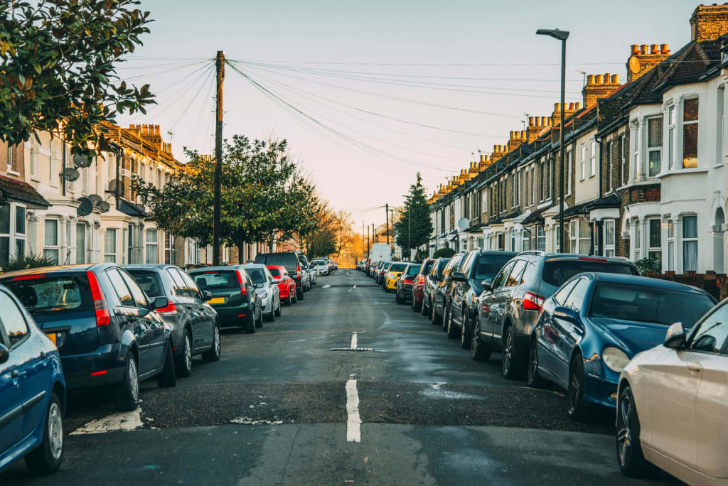 Residential street with tightly parked cars on both sides